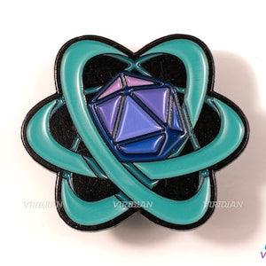 May include: A teal and black enamel pin featuring a stylized atom symbol with a purple and blue geometric die in the center.