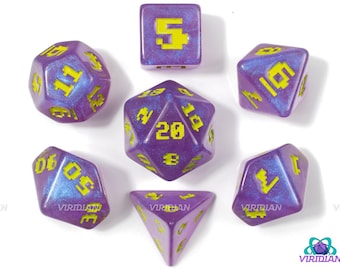 May include: Set of seven purple and yellow dice with a glittery finish. The dice are numbered 1-6, 10, and 20. The dice are for role-playing games.