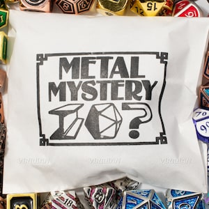 May include: A white bag with the text "METAL MYSTERY?" printed on it. The bag is surrounded by various metal dice with different colors and numbers.