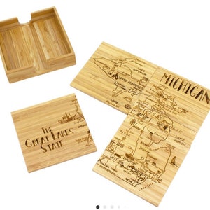 May include: Set of four wooden coasters featuring a map of Michigan with the text "The Great Lakes State" on one coaster. The coasters come in a wooden box.