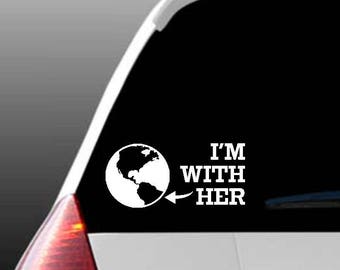 May include: White vinyl car sticker with a globe and the text "I'm With Her".