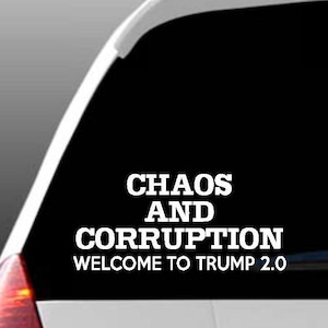 May include: A black car with a white vinyl sticker that reads "Chaos and Corruption Welcome to Trump 2.0".