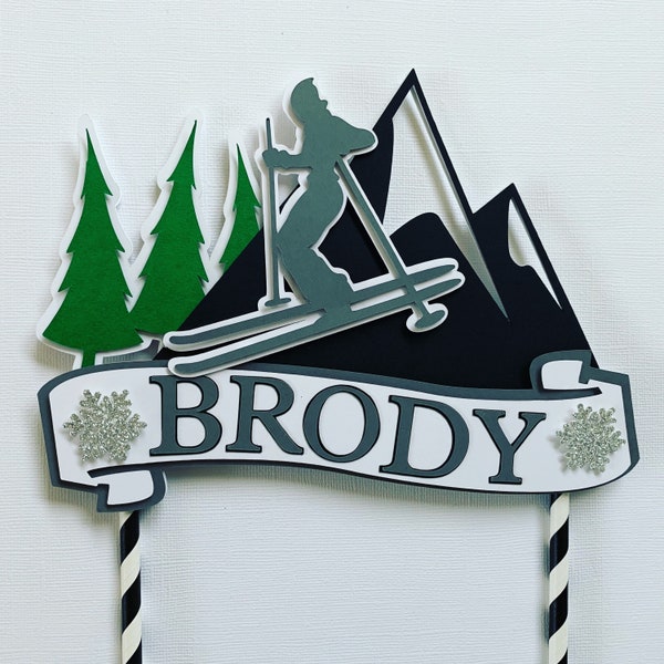 Skiing cake topper with personalized name.