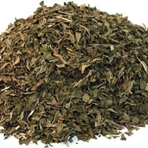 May include: Dried green mint leaves, a pile of finely chopped mint for cooking or herbal tea.