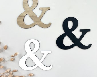 Ampersands {& characters} made of wood, matching the name tags