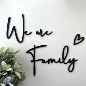 Black wooden lettering {We are Family} wall decoration, matching photo collage