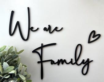 Black wooden lettering {We are Family} wall decoration, matching photo collage