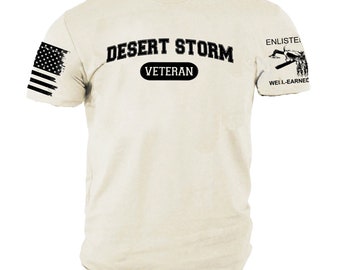 May include: Cream-colored t-shirt with the text "DESERT STORM VETERAN" in black, along with an American flag graphic on the left sleeve and military-themed graphics on the right sleeve. The shirt is size XL.