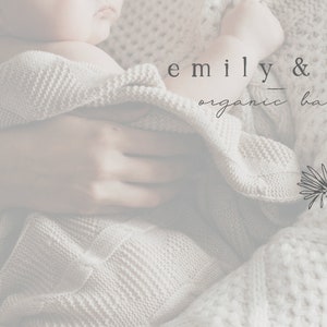 May include: A close-up of a person holding a baby wrapped in a white knitted blanket. The text "emily & ivy organic baby" is visible in the image.