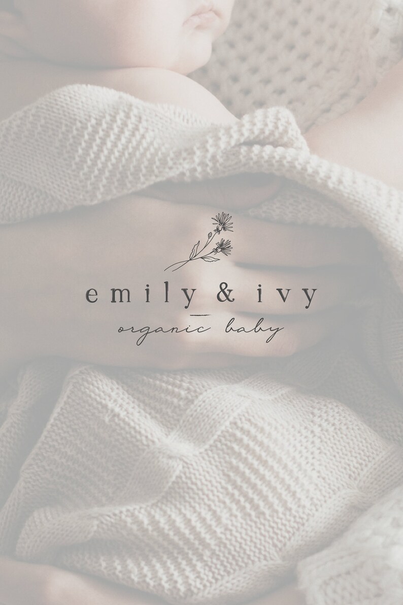 May include: A close-up of a baby wrapped in a white knitted blanket. The image features a logo with the text "emily & ivy organic baby" and a simple floral design.