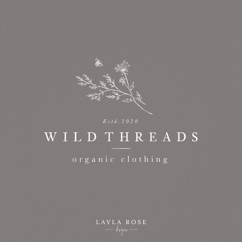 May include: A white logo design on a gray background with the text "Wild Threads organic clothing" and "Estd. 2020". The logo also features a stylized drawing of a flower and a bee.