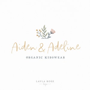 May include: Aiden & Adeline Organic Kidswear logo featuring a floral design in shades of green, pink, and yellow. The text is in a gold script font.