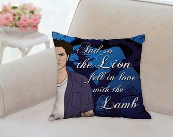 May include: A blue and white throw pillow with a cartoon illustration of a man and the text "And so the Lion fell in love with the Lamb".