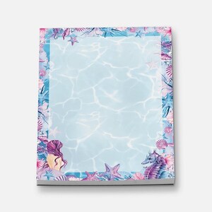 May include: A blue and pink notepad with a mermaid, seashells, and starfish border. The notepad has a light blue background with a water ripple pattern.