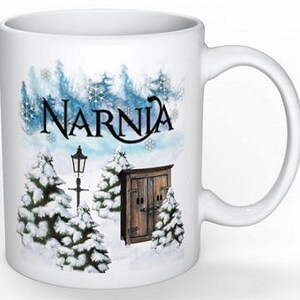May include: White ceramic mug with a winter scene featuring a snowy forest, a lamppost, a wooden door, and the word "Narnia" in blue lettering.