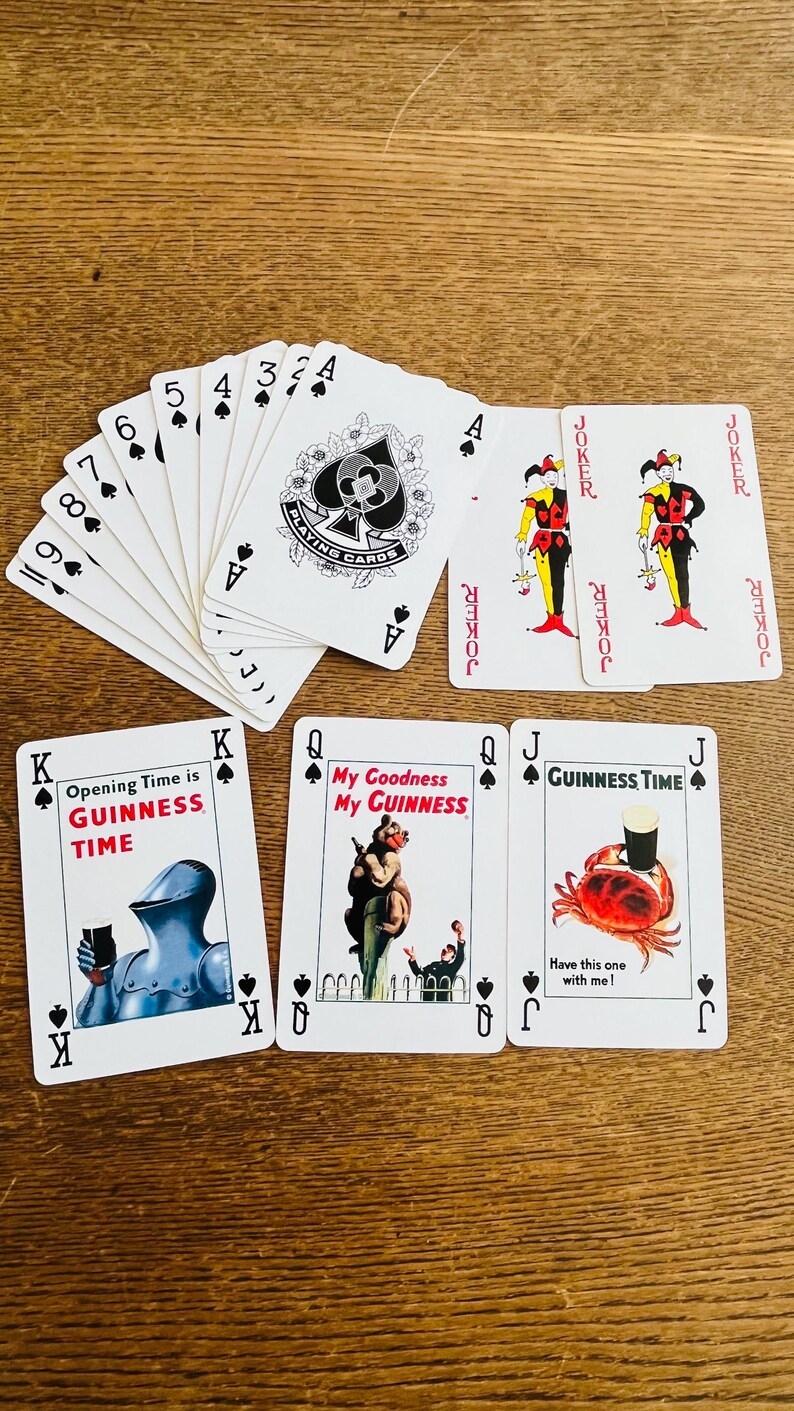May include: A collection of playing cards featuring a Guinness theme. The cards include various suits, face cards, and jokers. Some cards have illustrations and text like "Opening Time is GUINNESS TIME" and "My Goodness My GUINNESS".