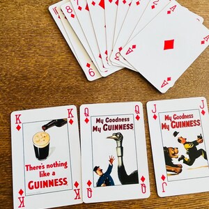 May include: A deck of playing cards with a joker card and several diamond suit cards. Three cards feature Guinness advertisements with text like "My Goodness My Guinness" and "There's nothing like a Guinness."