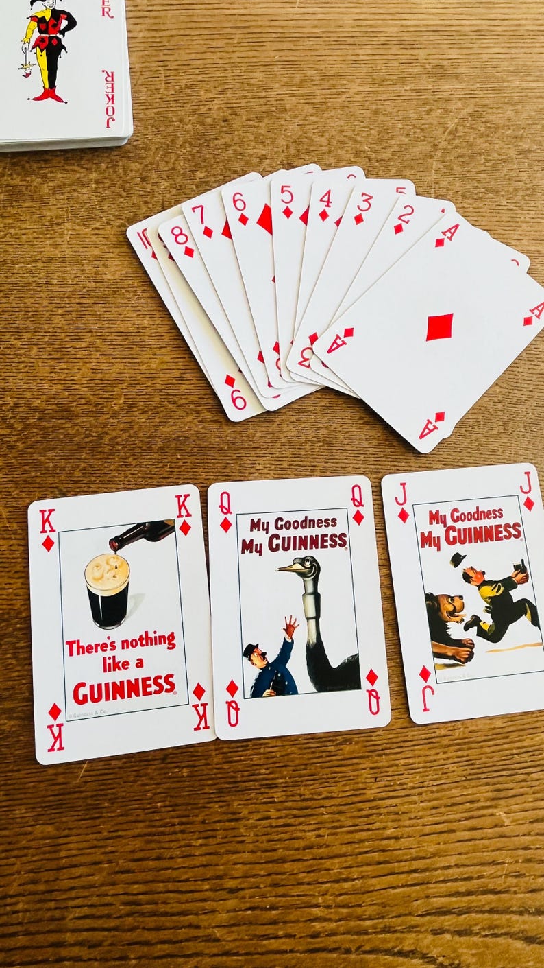 May include: A deck of playing cards with a joker card and several diamond suit cards. Three cards feature Guinness advertisements with text like "My Goodness My Guinness" and "There's nothing like a Guinness."