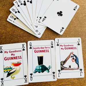 May include: Playing cards featuring the suits of clubs, with the Ace, 2, 3, 4, 5, 6, 7, 8, and 9 of clubs visible. Three additional cards feature the text "My Goodness My Guinness" and "Lovely day for a Guinness" with illustrations.