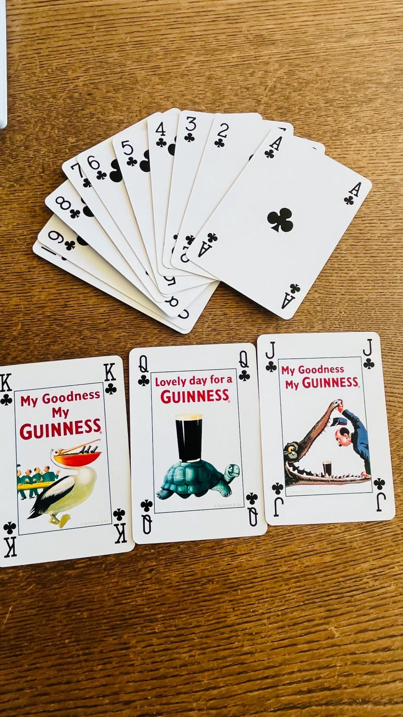 May include: Playing cards featuring the suits of clubs, with the Ace, 2, 3, 4, 5, 6, 7, 8, and 9 of clubs visible. Three additional cards feature the text "My Goodness My Guinness" and "Lovely day for a Guinness" with illustrations.