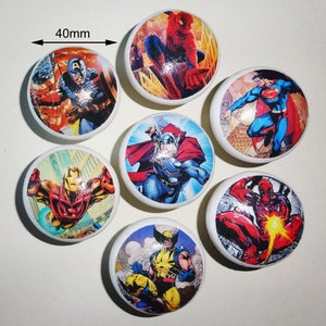 May include: Set of 7 round, ceramic knobs featuring various superhero characters. Each knob is 40mm in diameter and features a different superhero, including Spider-Man, Captain America, Thor, Wolverine, Iron Man, and Deadpool.