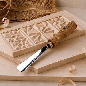 May include: A wood carving chisel with a wooden handle branded with the text STRYI, featuring a polished metal blade. The tool rests on a rectangular wooden block with intricate geometric carvings, accompanied by light wood shavings.