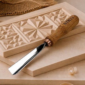 May include: A wood carving chisel with a wooden handle branded with the text STRYI, featuring a polished metal blade. The tool rests on a rectangular wooden block with intricate geometric carvings, accompanied by light wood shavings.