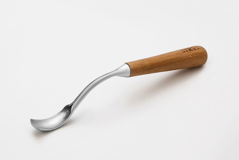 以下が含まれることがあります： カーブしたデザインのステンレス鋼彫刻スプーン。スプーンは、"STRYI"の文字が刻まれた木製のハンドルを備えています。スプーンは、詳細な木工用に設計されています。