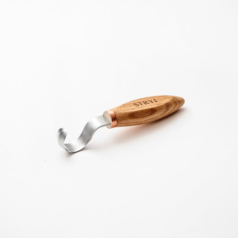 May include: A wooden handled carving tool with a metal hook. The handle is engraved with the word "STRYH".
