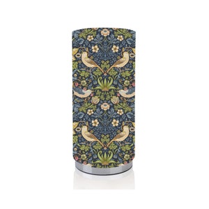 May include: A blue and green patterned table lamp with a silver base. The pattern features birds and flowers.