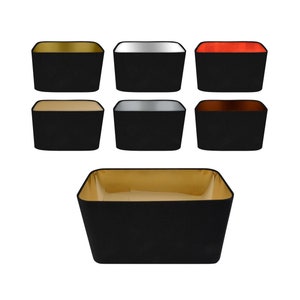 May include: A set of 10 black fabric lampshades with different coloured inner linings. The shades are square and have a modern design.