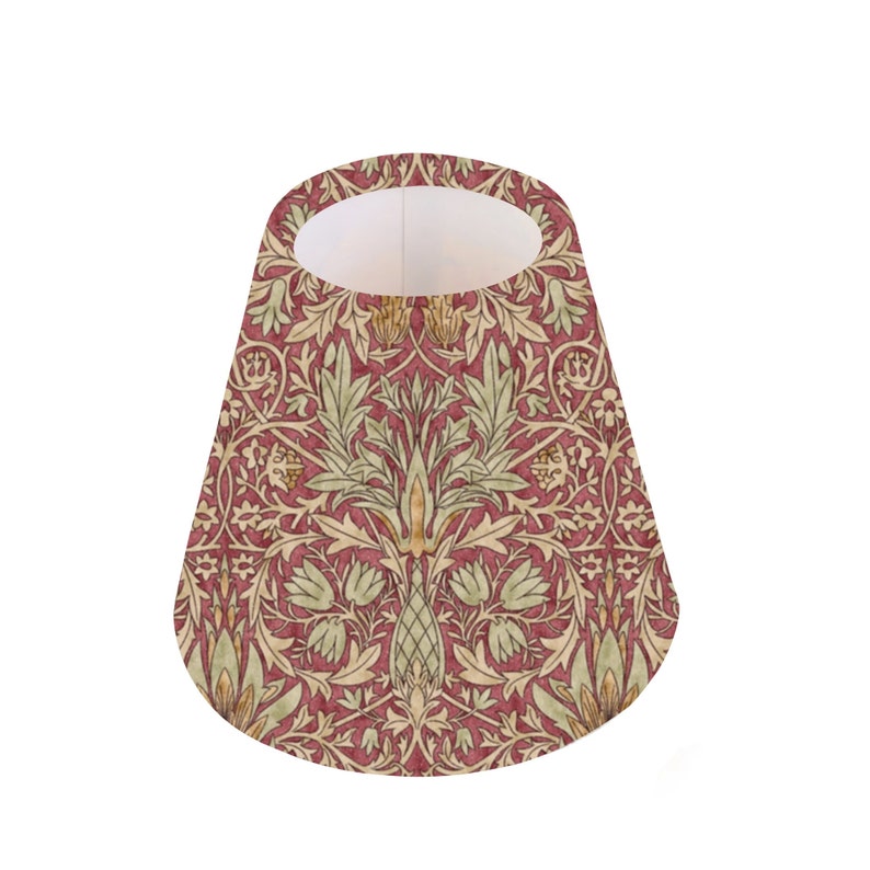 May include: A red, green, and gold patterned lampshade with a cone shape.