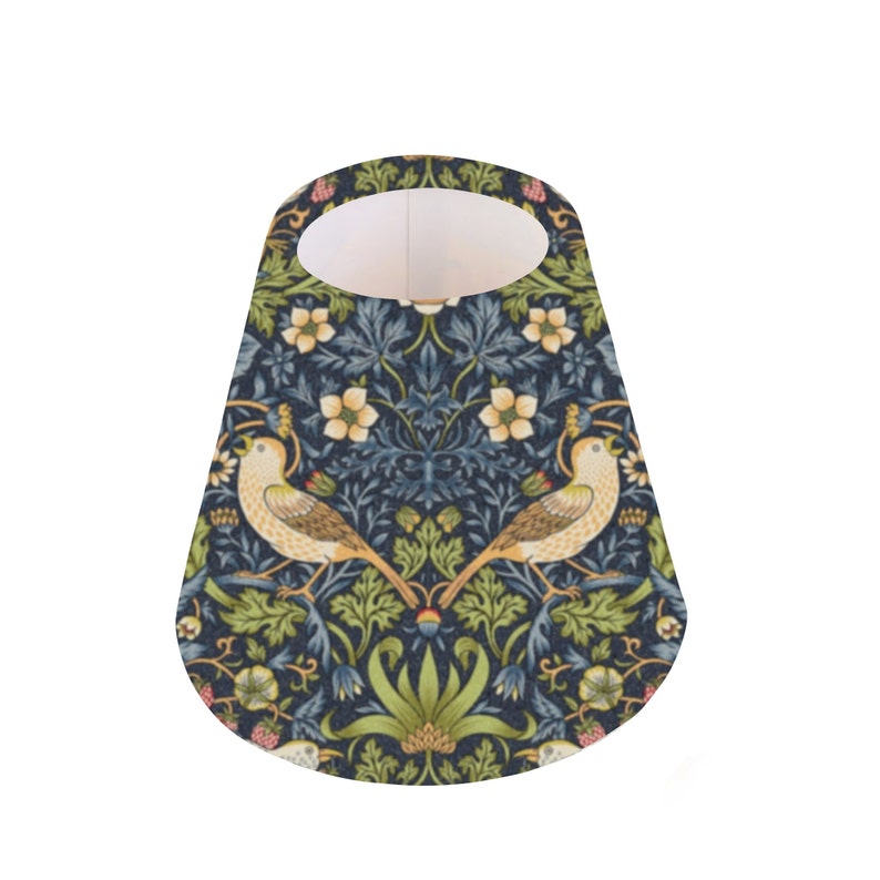 May include: A cone-shaped lampshade with a blue background and a floral pattern featuring birds, leaves, and flowers. The lampshade is made of fabric and has a white interior.