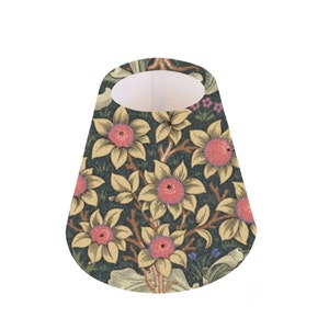 May include: A cone-shaped lampshade with a floral pattern. The pattern features yellow flowers with pink centers on a dark green background.