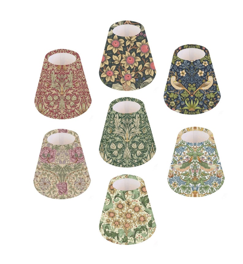 May include: Set of seven lampshades featuring different floral and bird patterns in shades of green, blue, red, and yellow. The lampshades are all cone-shaped and have a white interior.