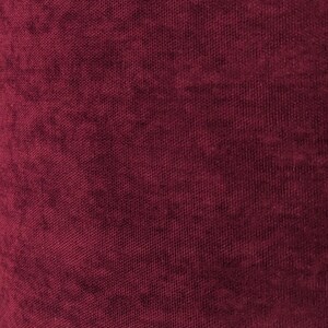 May include: Close-up of a deep burgundy fabric with a textured woven pattern.