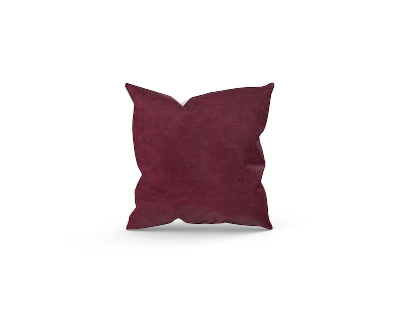 May include: A burgundy velvet throw pillow with a square shape.