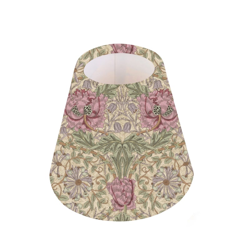 May include: A cone-shaped lampshade with a floral pattern. The pattern features pink flowers, green leaves, and a beige background.