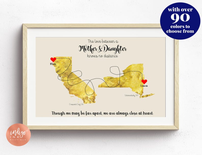 May include: A gold foil map of the United States with a red heart marking California and New York. The text reads "The love between a Mother & Daughter knows no distance. Though we may be far apart, we are always close at heart."