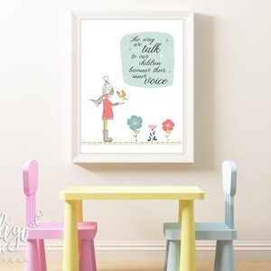 May include: A framed art print featuring a whimsical illustration of a child with a bird, accompanied by the text "The way we talk to our children becomes their inner voice." The artwork includes colorful flowers and is displayed above a yellow table and pink and blue chairs.