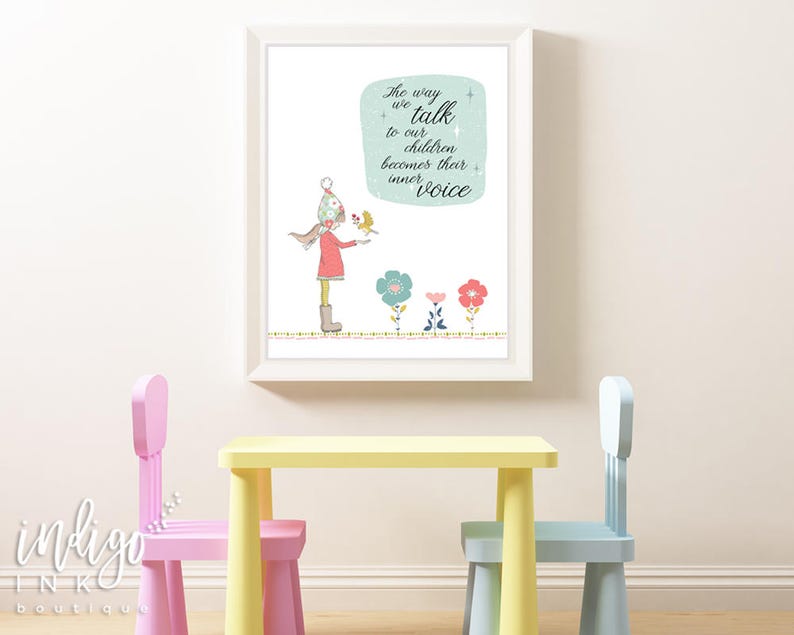 May include: A framed art print featuring a whimsical illustration of a child with a bird, accompanied by the text "The way we talk to our children becomes their inner voice." The artwork includes colorful flowers and is displayed above a yellow table and pink and blue chairs.