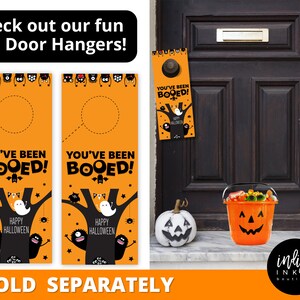 May include: Two orange and black Halloween door hangers with the text "We've Been Booed!" and "You've Been Booed!"  Each hanger features a ghost, bats, and spiders on a tree with the text "Happy Halloween".
