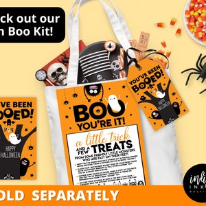 May include: A Halloween-themed tote bag with a ghost and monster design. The bag is filled with treats and a tag that says "You've Been Booed!"  The text "Boo You're It!" and "A Little Trick and a Few Treats" are printed on the bag.  The bag is sold separately.