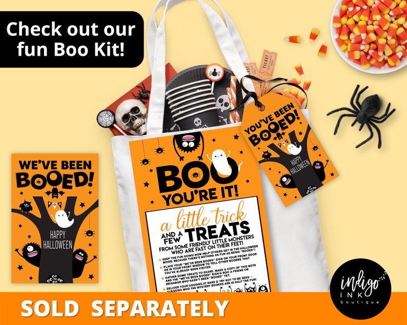 May include: A Halloween-themed tote bag with a ghost and monster design. The bag is filled with treats and a tag that says "You've Been Booed!"  The text "Boo You're It!" and "A Little Trick and a Few Treats" are printed on the bag.  The bag is sold separately.