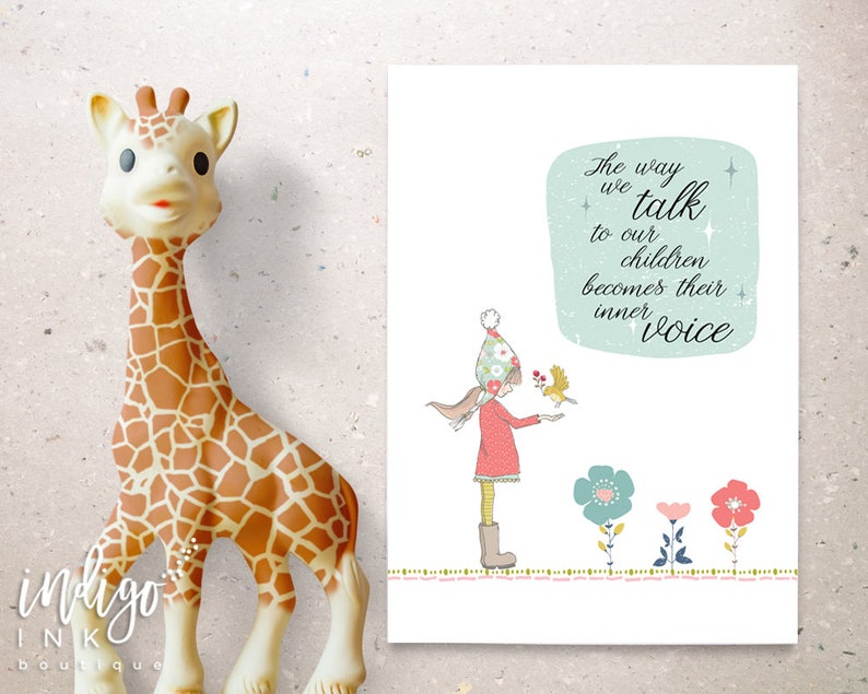 May include: A soft, tan giraffe toy with brown spots stands next to a print with the text "The way we talk to our children becomes their inner voice." The print features a girl with a bird and colorful flowers.
