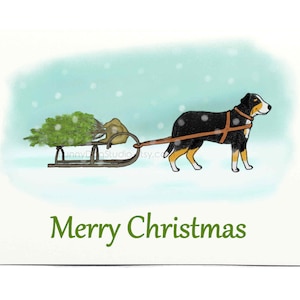 May include: A black and brown dog pulls a sled with a Christmas tree through a snowy landscape. The text "Merry Christmas" is written below the image.