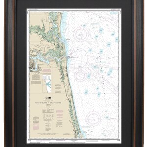 May include: A nautical chart of Amelia Island to St. Augustine, Florida. The chart shows the coastline, waterways, and navigational aids. The chart is printed in black and white with blue and red accents.