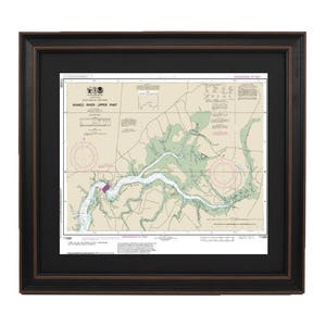 May include: A framed nautical chart of the Chesapeake Bay, showing the area around the mouth of the Rappahannock River. The chart is printed in black, white, and green, and includes depth soundings and other navigational information.