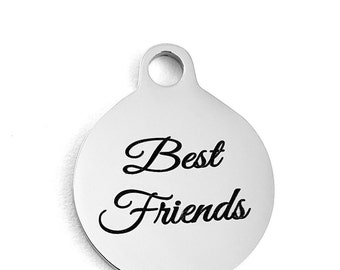May include: A silver round charm with a hole at the top and the words "Best Friends" engraved in black cursive lettering.