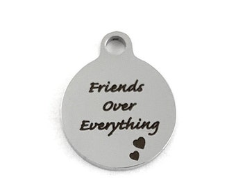 May include: Silver charm with the text "Friends Over Everything" and two small hearts.